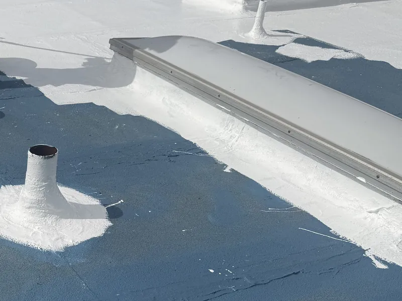 Flat roof silicone seal in progress